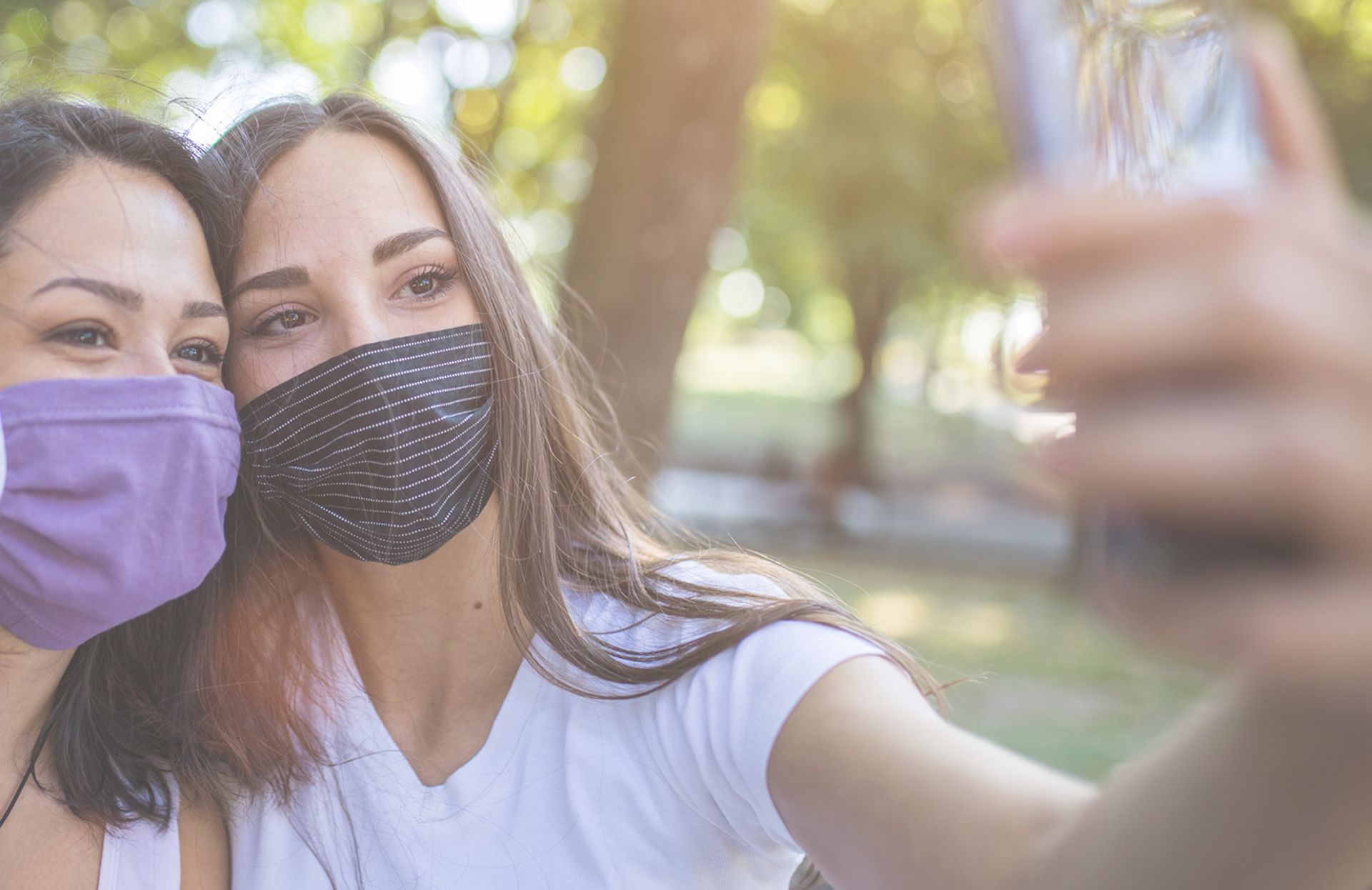 Two women taking a selfie with masks on