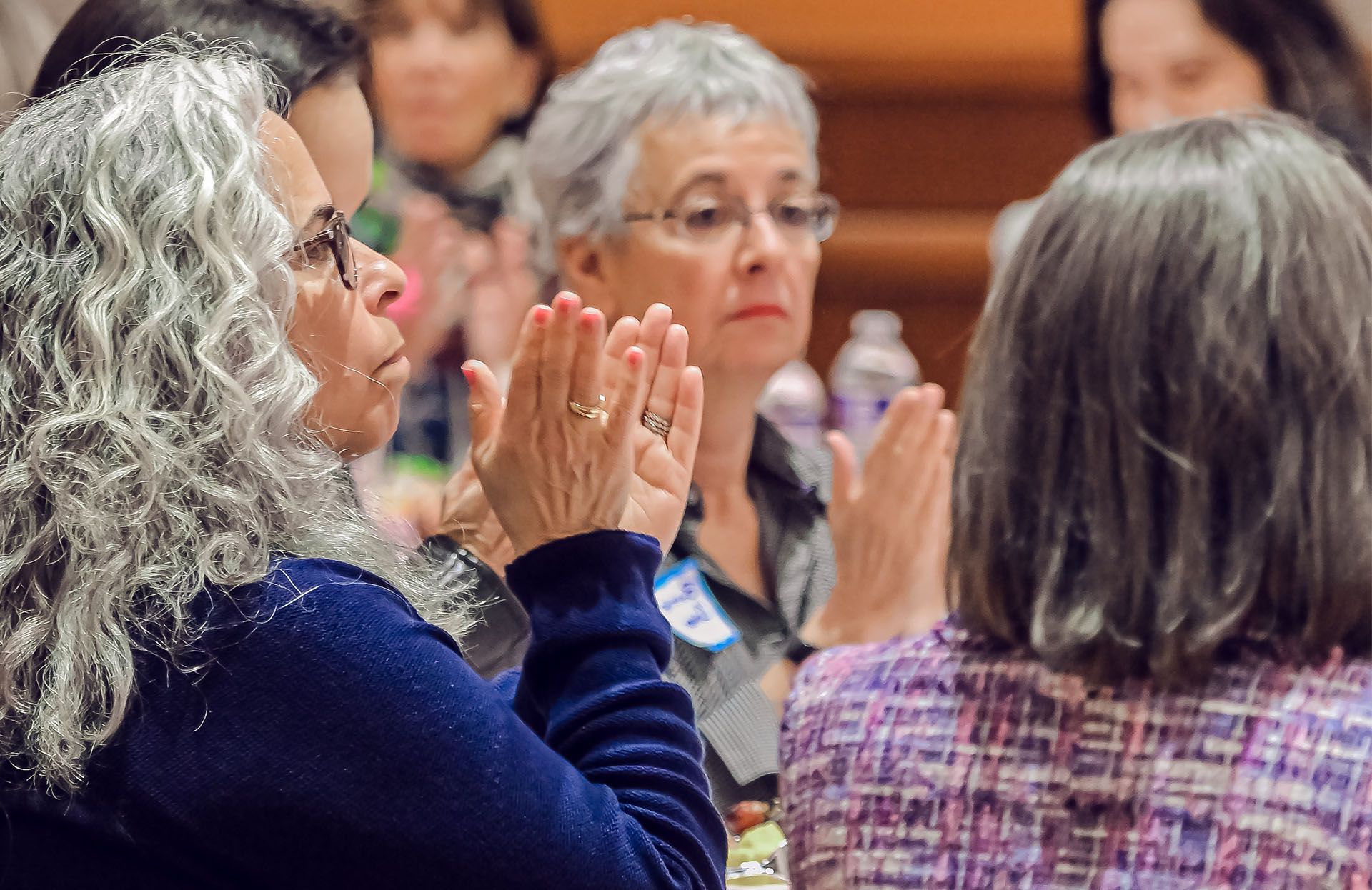 Image of women sitting at a conference table