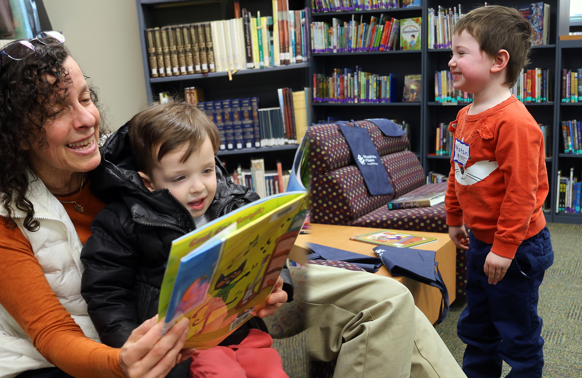 Image of woman reading to girl and of a young boy smiling