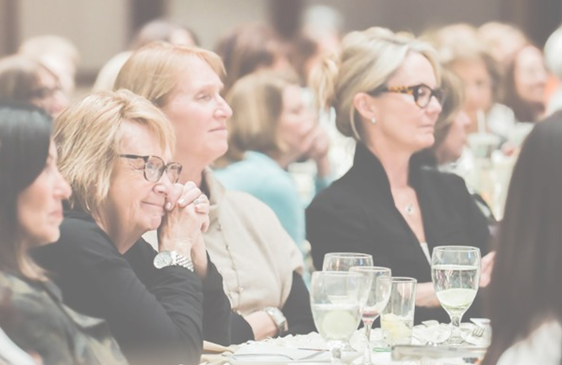 Image of women sitting at a conference table